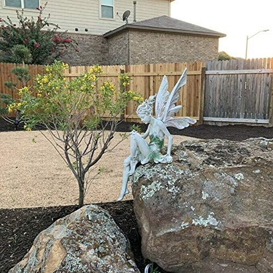 Statue of sitting fairy in the garden
