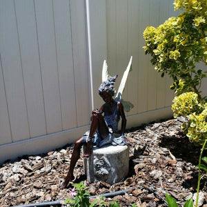 Statue of sitting fairy in the garden