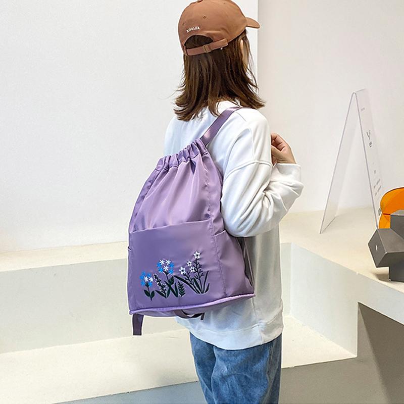 Multifunctional travel backpack with drawstring and embroidery