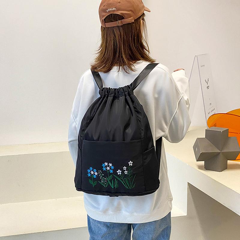 Multifunctional travel backpack with drawstring and embroidery