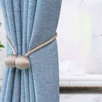 Curtain tiebacks with magnetic curtain clasp