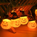 Glowing pumpkin garland Halloween with witch hats
