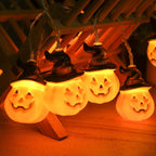 Glowing pumpkin garland Halloween with witch hats
