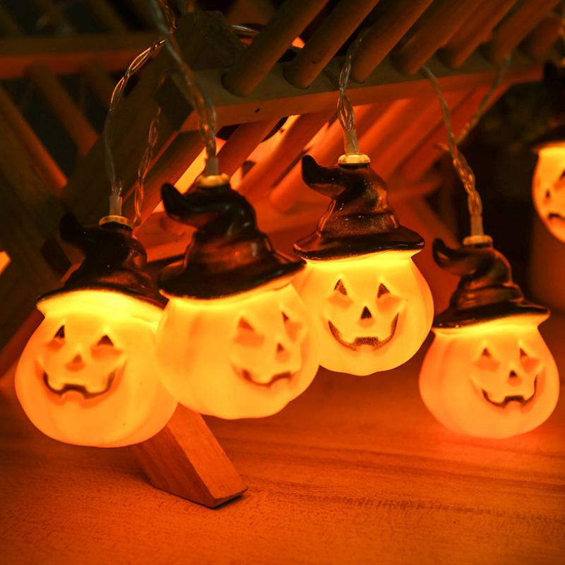 Glowing pumpkin garland Halloween with witch hats