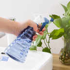 Adjustable spray bottle with ergonomic grip for easy handling and versatile use