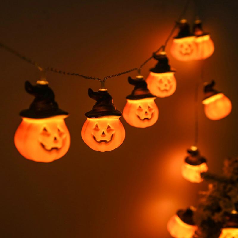 Glowing pumpkin garland Halloween with witch hats