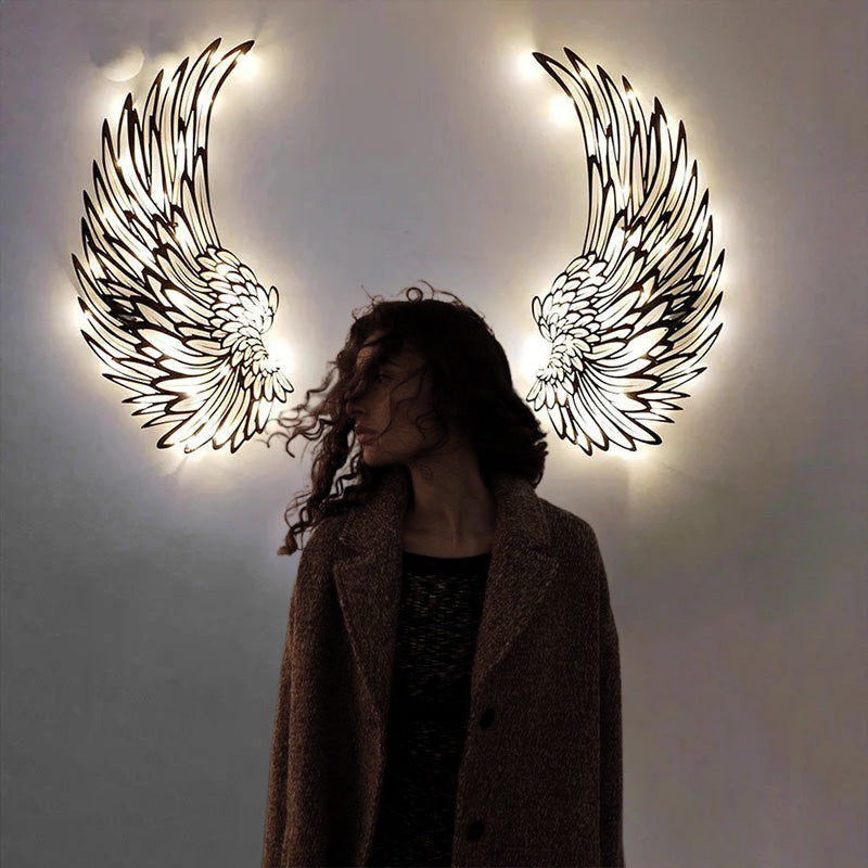 Metal wall art with angel wings and LED lights
