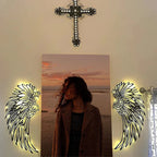 Metal wall art with angel wings and LED lights
