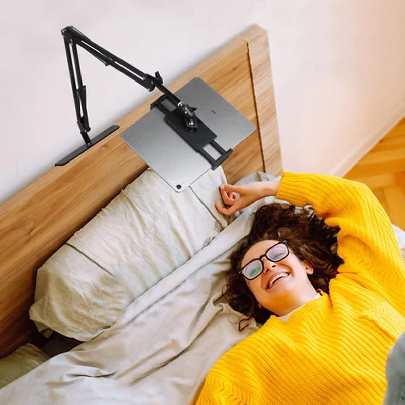 Extendable, concealed phone/tablet holder at the bed
