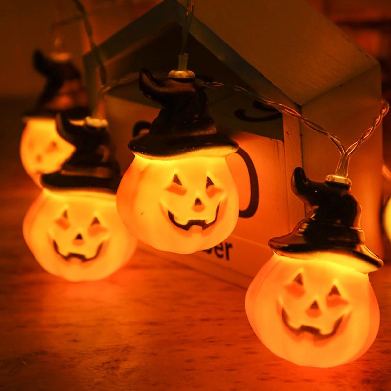 Glowing pumpkin garland Halloween with witch hats