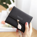 Short wallet with three folds and leaf decor