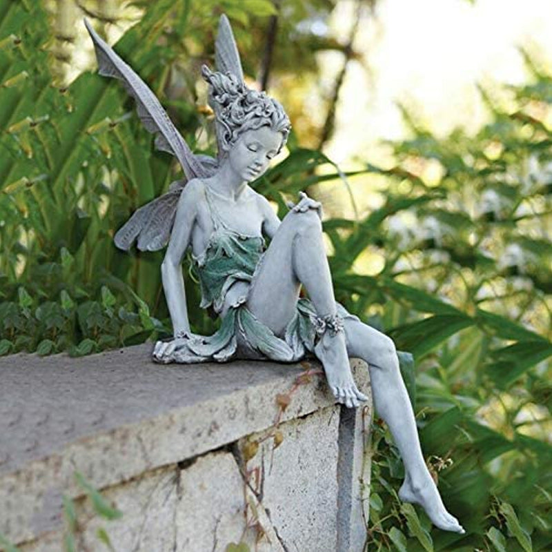 Statue of sitting fairy in the garden