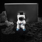 Support for phones or pens in astronaut decorations