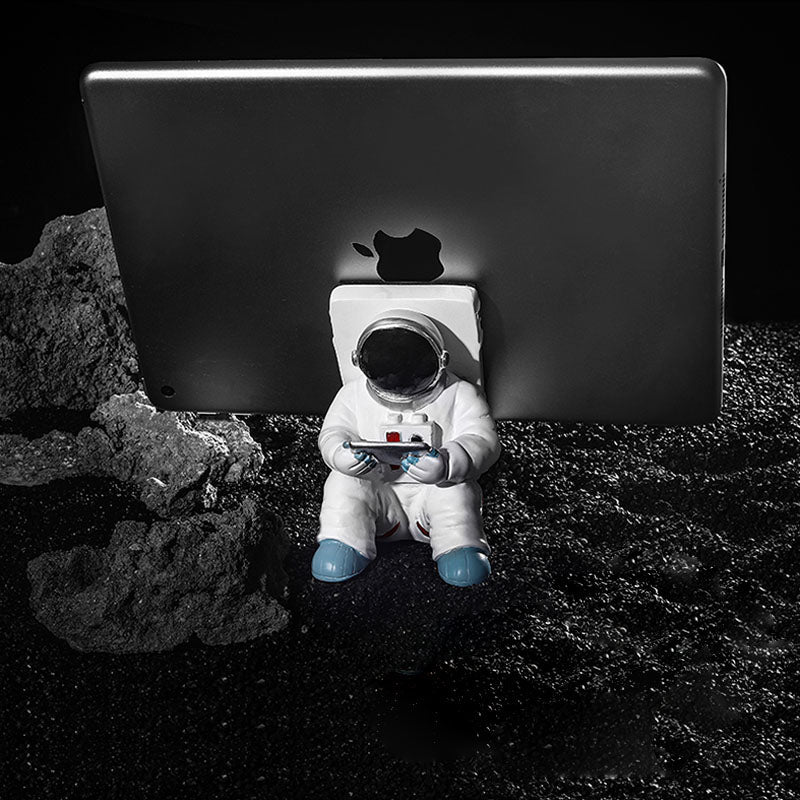 Support for phones or pens in astronaut decorations