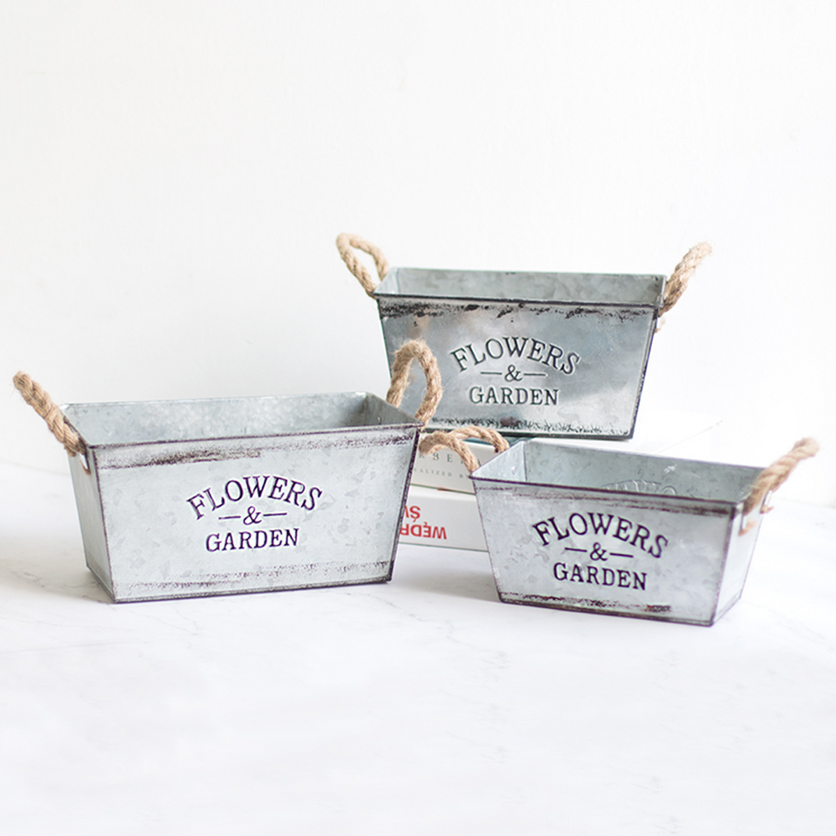 Decorative flower and garden container made of metal with hemp rope handles