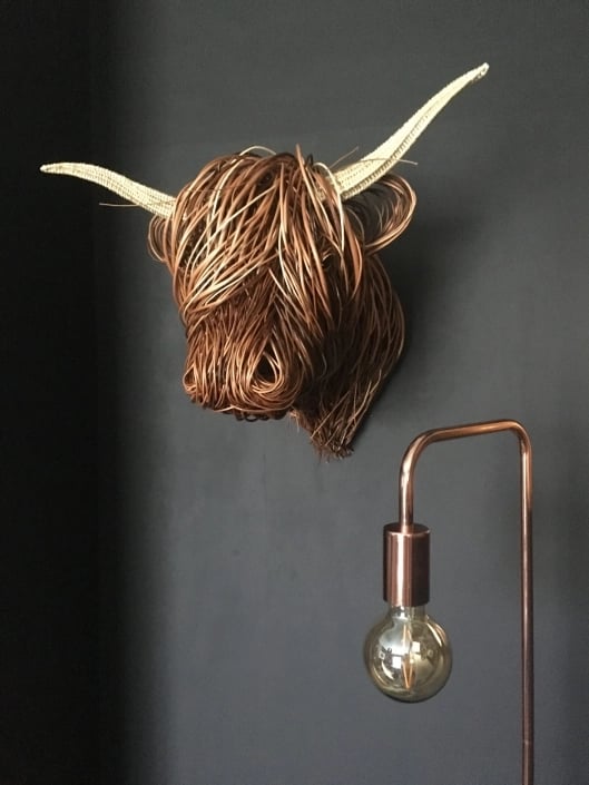 Elegant cow wall sculpture in country house style