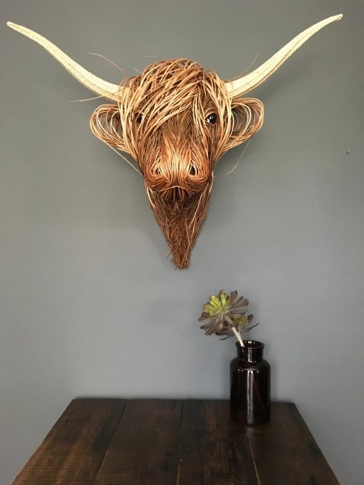 Elegant cow wall sculpture in country house style