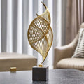 Golden abstract shell sculptures