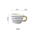 Cup with abstract geometric pattern and gold handle