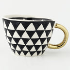 Cup with abstract geometric pattern and gold handle