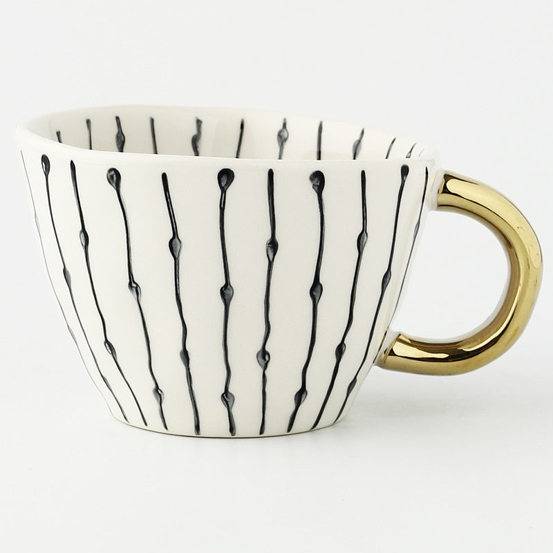 Cup with abstract geometric pattern and gold handle