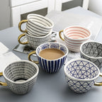Cup with abstract geometric pattern and gold handle