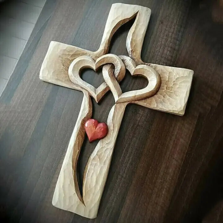 Hand-carved wooden cross with intertwined hearts