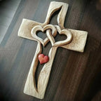 Hand-carved wooden cross with intertwined hearts