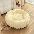 Round donut dog bed made of plush with non-slip bottom