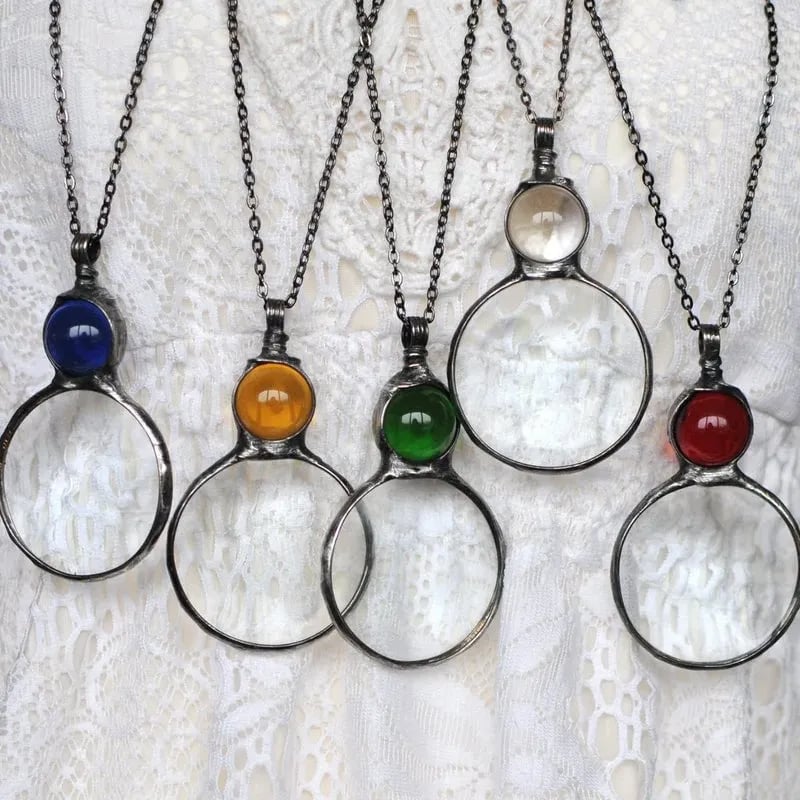 Necklace with magnifying pendant