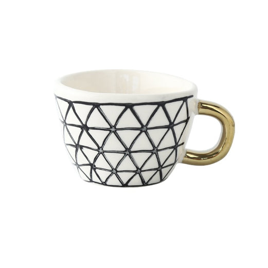 Cup with abstract geometric pattern and gold handle