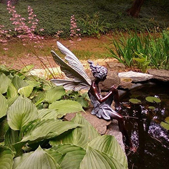 Statue of sitting fairy in the garden