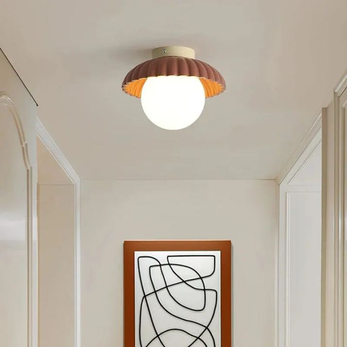 Ceiling lamp with a milk glass shade providing warm lighting in the hallway