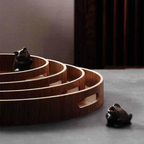 Slim, round serving trays made of wood