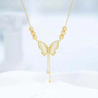 Necklace with gold-colored butterfly with tassels