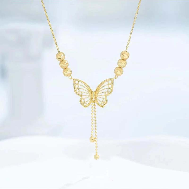 Necklace with gold-colored butterfly with tassels