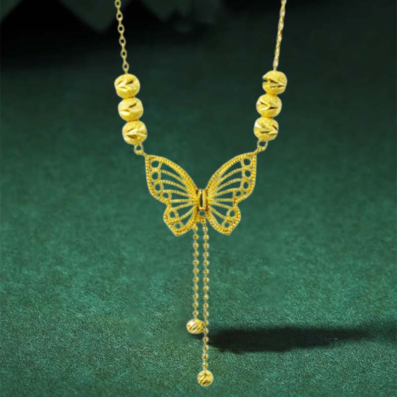 Necklace with gold-colored butterfly with tassels