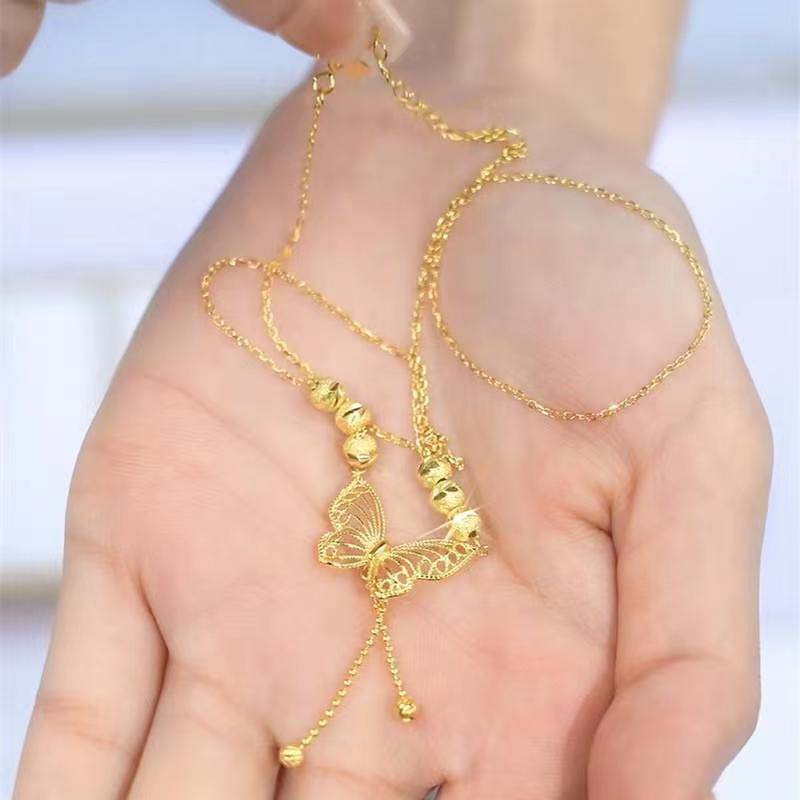 Necklace with gold-colored butterfly with tassels