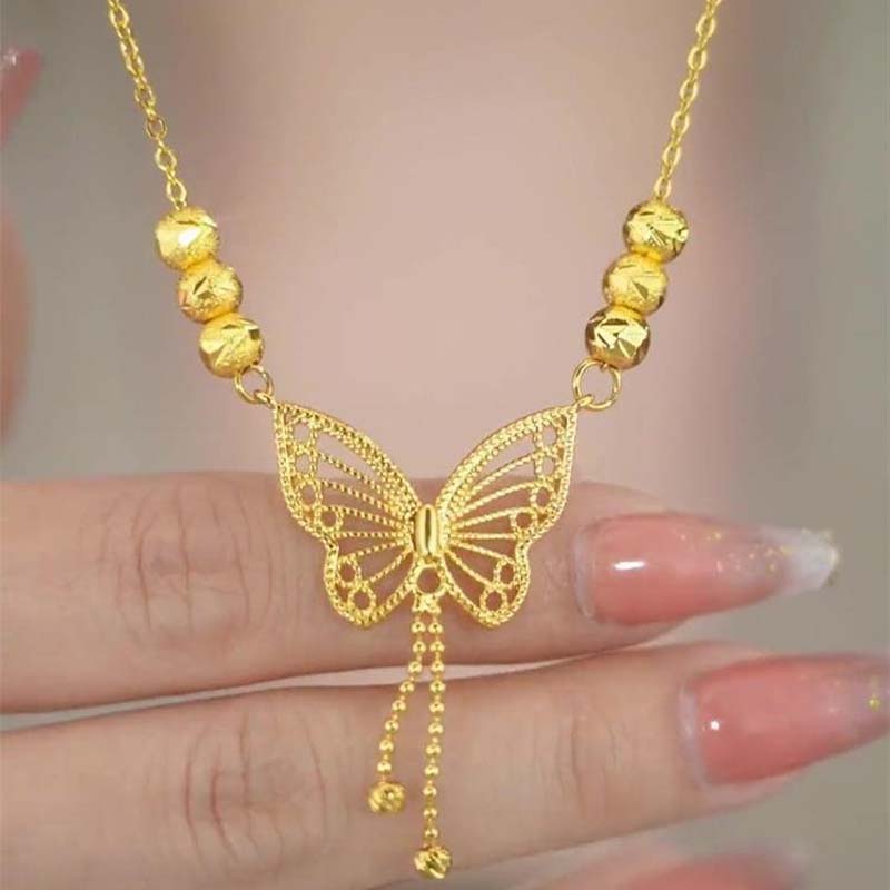 Necklace with gold-colored butterfly with tassels