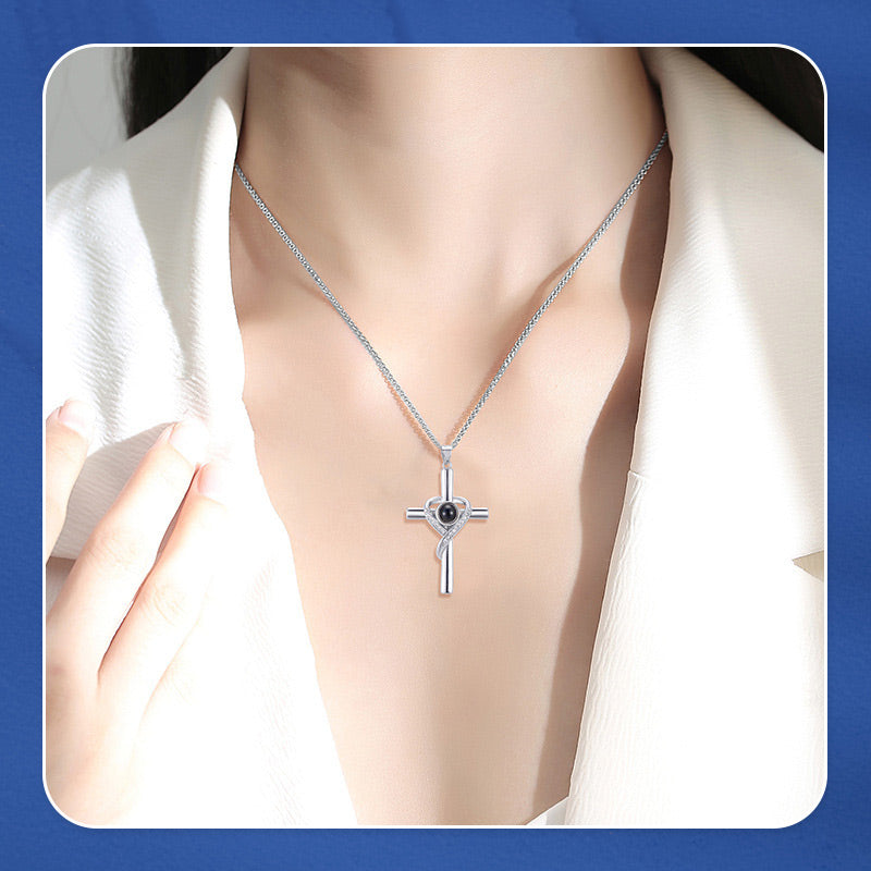 Cross necklace with "I love you" projection in 100 languages