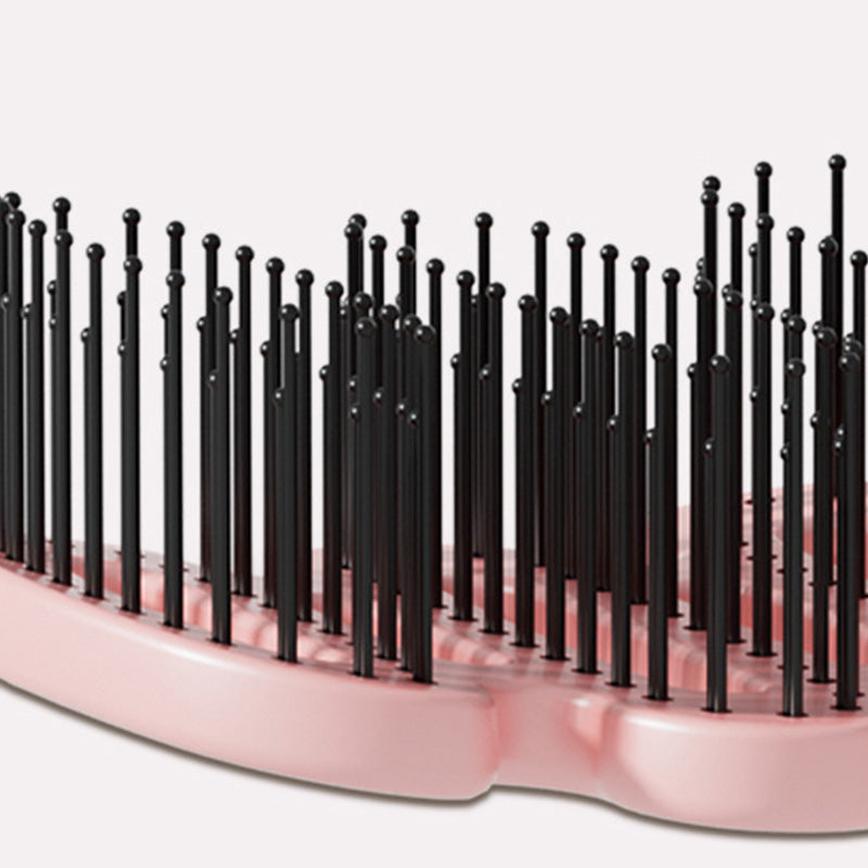 Curved hairbrush with ventilation