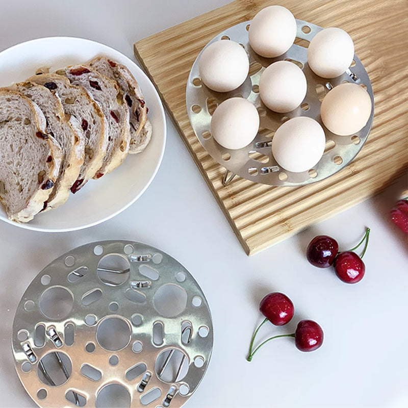 Silver-colored steamer rack in stainless steel with support for cooking