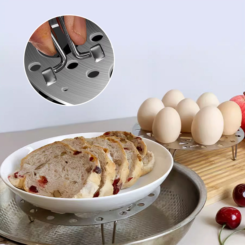 Silver-colored steamer rack in stainless steel with support for cooking