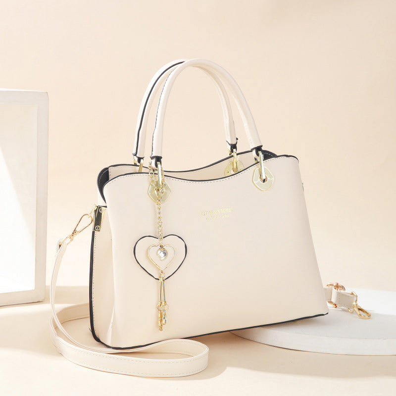Elegant women's handbag with sparkling heart pendant